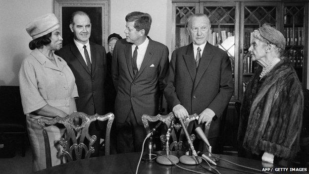 German Chancellor Konrad Adenauer (2nd R), US President John F. Kennedy (C), flanked by African-American contralto Marian Anderson (L), U.S. Senator George Stanley McGovern (2nd L) and Mrs Woodrow Wilson attend in November 1961 during a meeting for a foundation against hunger in the world, in Washington.