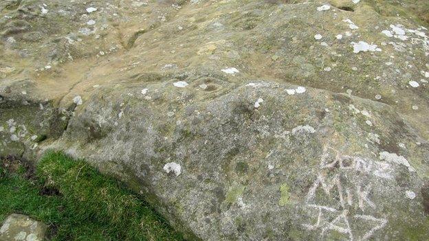 Damaged cup and ring stone