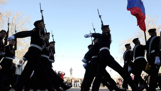 Russian naval infantry soldiers (marines) parade during the flower-laying ceremony at the Soviet-era World War II memorial in the Crimean port of Sevastopol on 3 April 2014