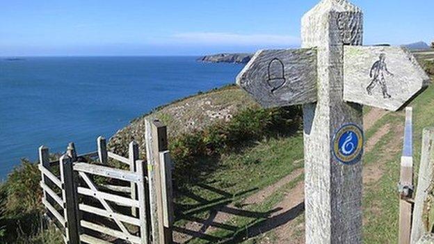 Path sign and path towards St Justinians, Pembrokeshire