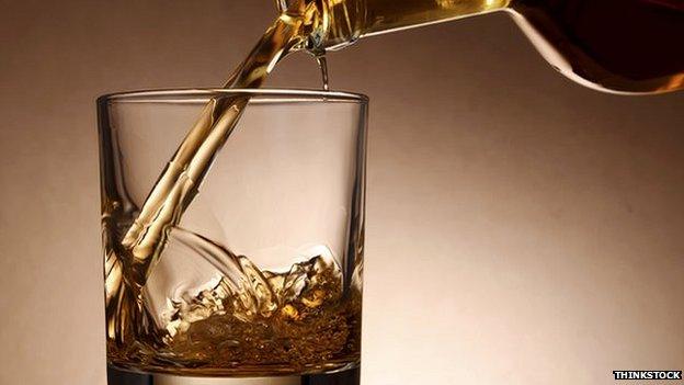 whisky being poured into a glass