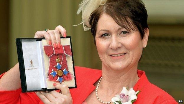 Julie Bailey proudly holds her CBE (Commander of the British Empire) award, after being presented with it by Queen Elizabeth II at the Investiture ceremony, at Buckingham Palace, in central London.