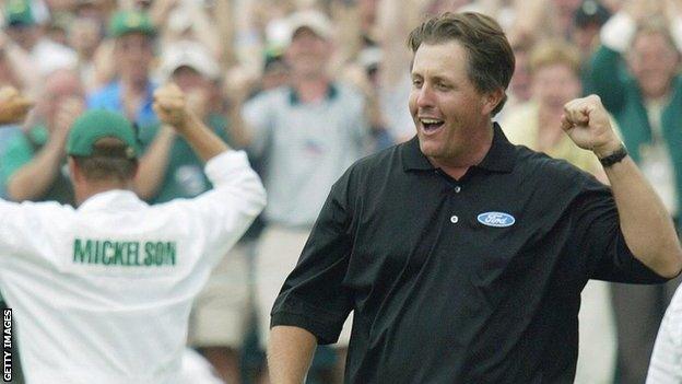 Phil Mickelson celebrates a birdie putt on the 18th green to win the 2004 Masters