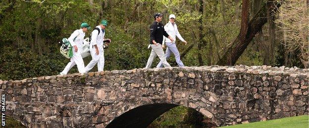 Rory McIlroy of Northern Ireland (right) and Patrick Reed of the US cross the Nelson Bridge on the 13th at Augusta during practice this week