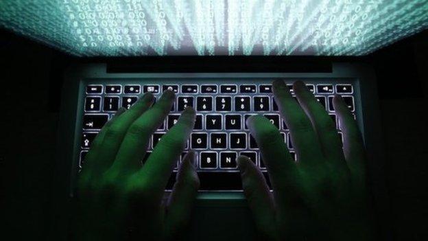 Person typing on a computer keyboard