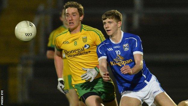 Cavan's Paul Graham gets the ball away despite the attentions of Donegal's Hugh McFadden