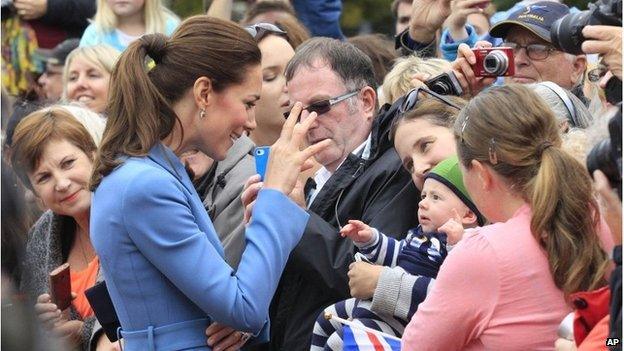 Duchess of Cambridge smiling at a baby