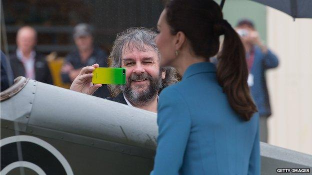 Peter Jackson takes a picture of Catherine as she inspects a plane