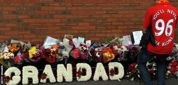 A Liverpool fan pays his respects to the 96 supporters who died at Hillsborough on 15 April 1989