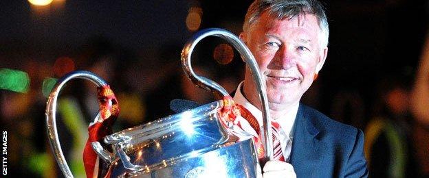 Six Alex Ferguson pictured with the Champions League trophy after United won it in 2008