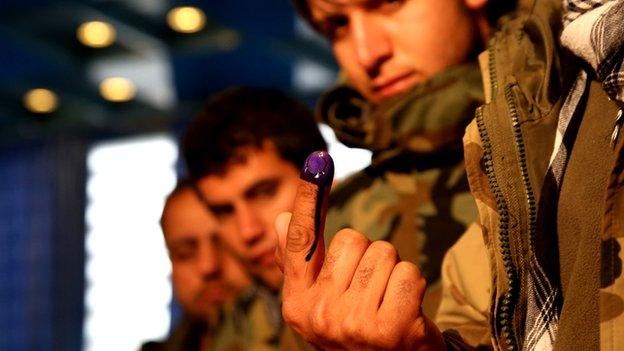 A voter shows off his inked finger to underline his support for the 2014 poll