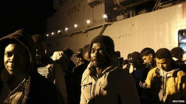 Migrants stand in line at the Sicilian harbour of Augusta April 9