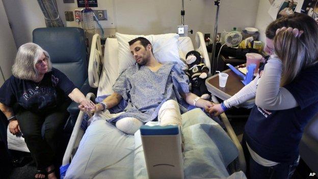 Marc Fucarile (centre) and Jen Regan (right) in a Boston, Massachusetts, hospital on 9 May 2013