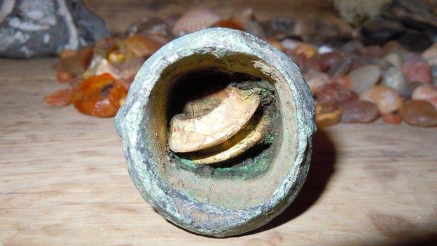 Bronze Age axe head containing gold rings