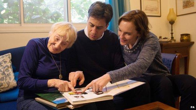 Ed Miliband with his wife Justine and his mother's cousin Sara, all looking at a picture album