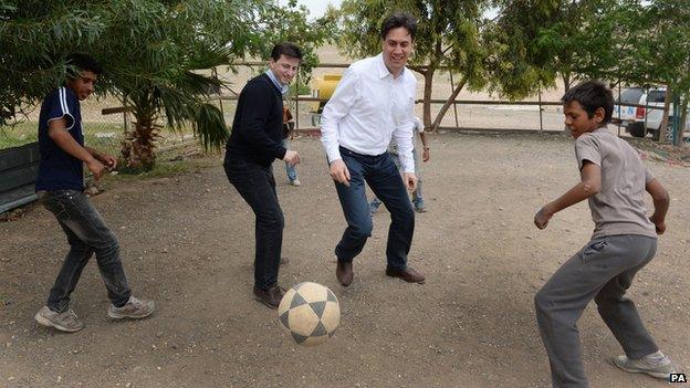 Shadow foreign secretary Douglas Alexander, second left, and Ed Miliband, second right enjoy a kick-about