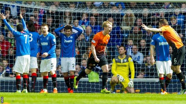 Rangers players are dejected as Gary Mackay-Steven celebrates Dundee United's second goal