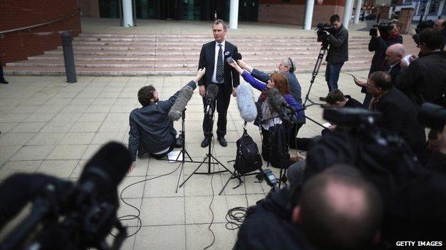 Nigel Evans surrounded by the press outside court