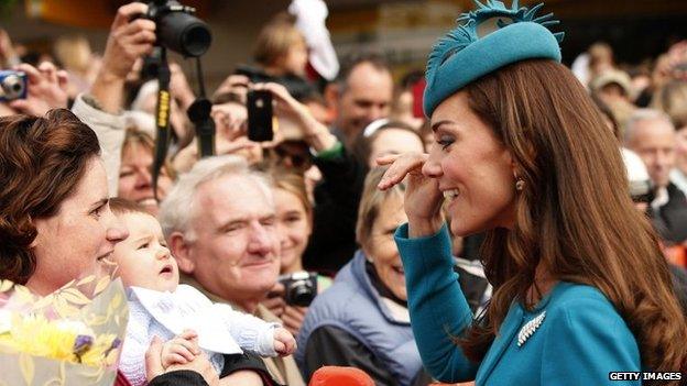 Catherine greets locals outside the service