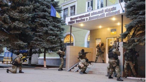 A group of camouflaged men storming the police headquarters