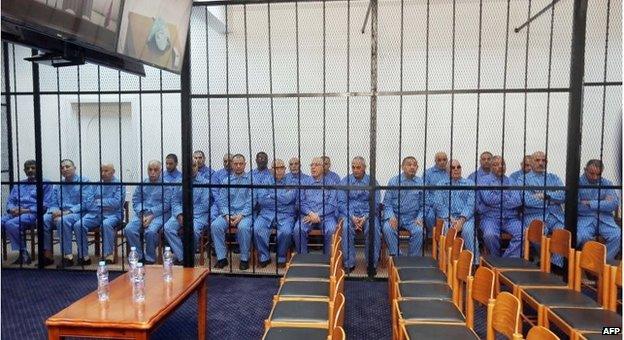 The 23 defendants in court on Monday