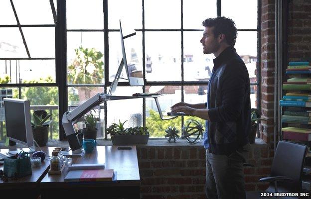 Man stands at workstation