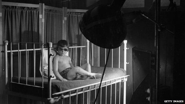 Child under a sun lamp, 1920s