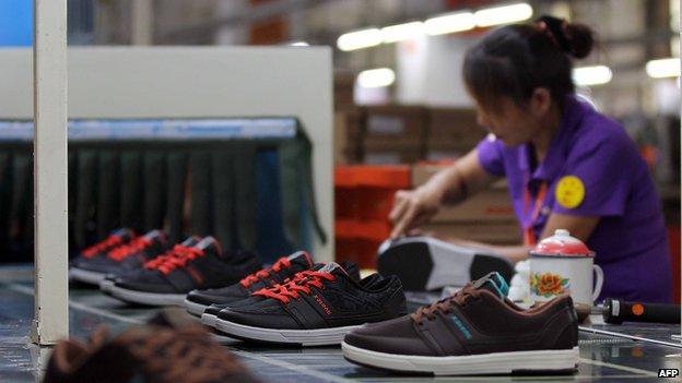 A labourer works in a shoe factory in Jinjiang, south China's Fujian province, 17 September 2013