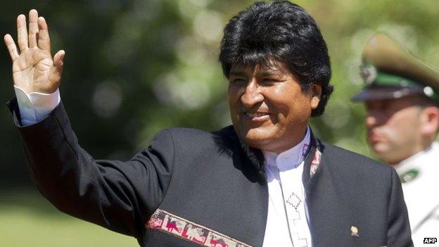 Bolivia's President Evo Morales waves at the press in Chile on March 11, 2014.