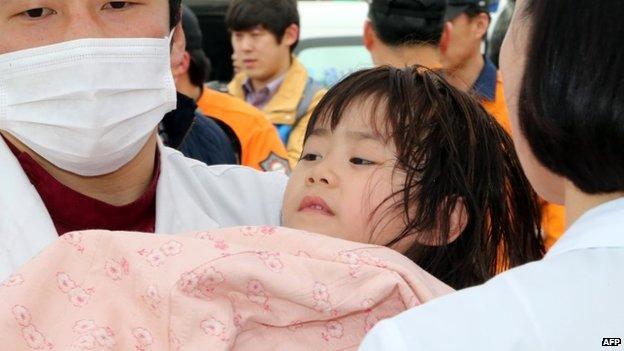 Rescued girl being brought onto land in Jindo