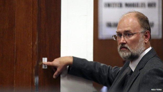 Forensic expert Roger Dixon points at the door through which Reeva Steenkamp was shot, 15 April 2014