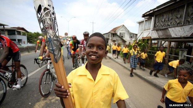 A student from Success Elementary School runs with the Queen's baton in Guyana.