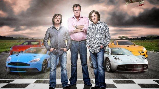 Richard Hammond, Jeremy Clarkson and James May stood in front of sports cars