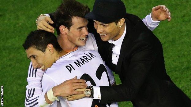 Gareth Bale (centre) embraced by Angel di Maria and Cristiano Ronaldo after scoring the winner in the Copa del Rey final