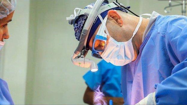 A surgeon operating on a patient