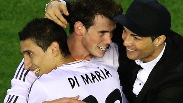 Gareth Bale (centre) embraced by Angel di Maria and Cristiano Ronaldo after scoring the winner in the Copa del Rey final