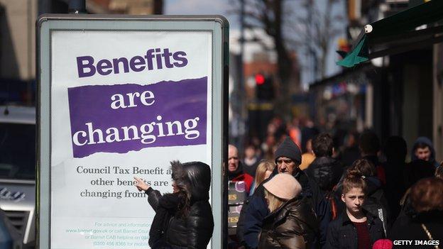 A poster informing pedestrians of changes to the benefits and tax system, on 2 April 2013, in London