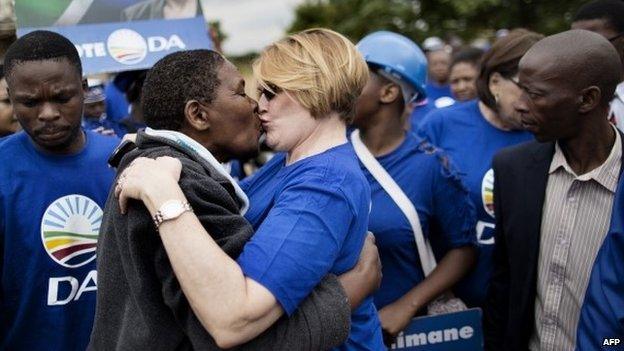 South African opposition leader Helen Zille kisses a resident of the Chris Hani informal settlement in Hammanskraal during a door-to-door campaign ahead of the 7 May elections.