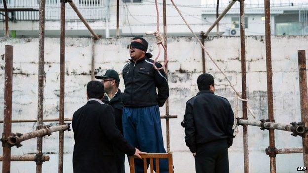 Balal, who killed Iranian youth Abdollah Hosseinzadeh in a street fight with a knife in 2007, reacts as he stands in the gallows during his execution ceremony in the northern city of Nowshahr on 15 April 2014