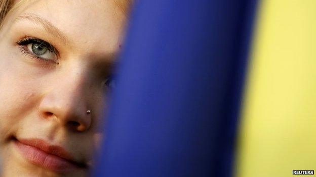 Pro-Kiev protester looks on behind a Ukrainian flag during a rally in Donetsk, in eastern Ukraine April 17, 2014