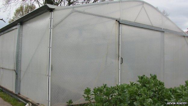 Kevin Fortey has set up the alarm system in his insulated greenhouse