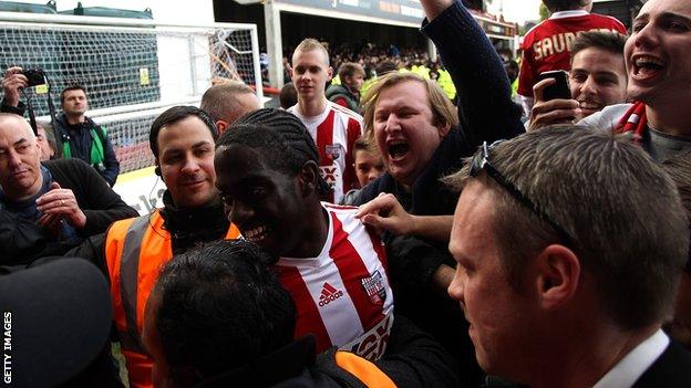 Clayton Donaldson is mobbed by Brentford fans after the Bees won promotion to the Championship