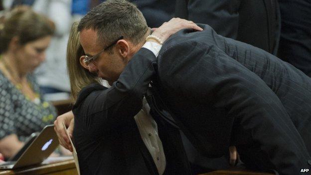 Oscar Pistorius hugs a family member in court (17 April 2014)