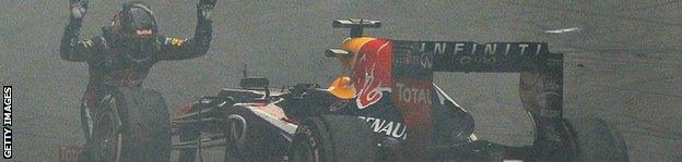 Red Bull driver Sebastian Vettel of Germany bows in front of his car as he celebrates after winning the Formula One Indian Grand Prix 2013 at the Buddh International circuit in Greater Noida.