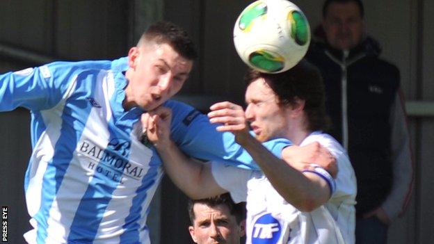 Warrenpoint striker Daniel Hughes in an aerial duel with Coleraine's Howard Beverland