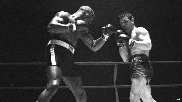 File photo: Rubin "Hurricane" Carter, left, knocks out Italian boxer Fabio Bettini in the 10th and last round of their fight at the Falais Des Sports in Paris, 23 February 1965