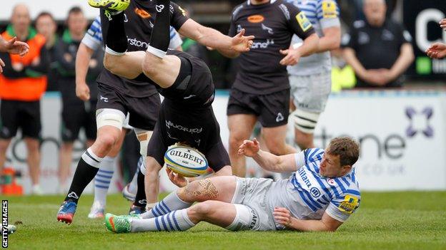 Alex Tait is tackled in the air by Saracens winger Jack Wilson.