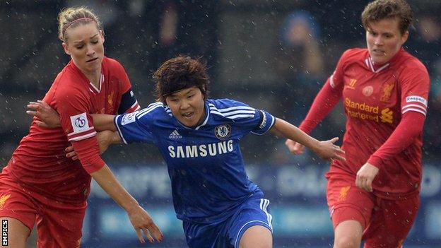 Chelsea's South Korean midfielder Ji So-Yun (centre) is flanked by Liverpool"s Gemma Bonner (left) and Katrin Omarsdottir (right)