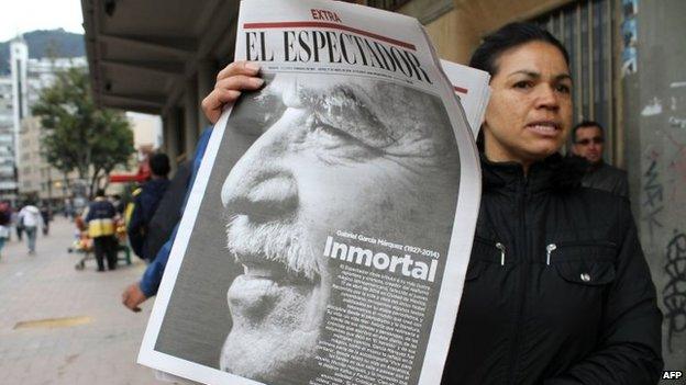 A newspaper vendor holds a newspaper announcing the death of Colombian author Gabriel Garcia Marquez on 18 April, 2014