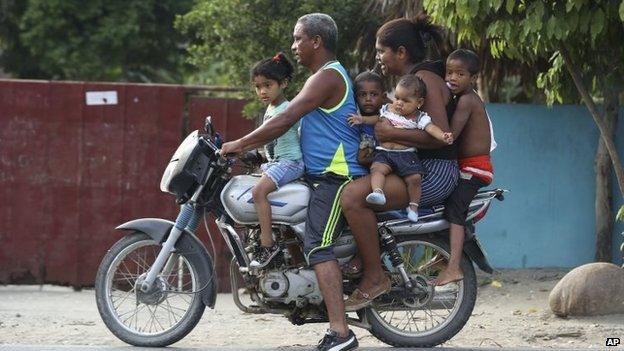 A family rides together on a motorbike in Aracataca, the hometown of the late Nobel laureate Gabriel Garcia Marquez along Colombia's Caribbean coast on 18 April, 2014